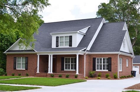 metal roof on red brick house|black shingles on brick house.